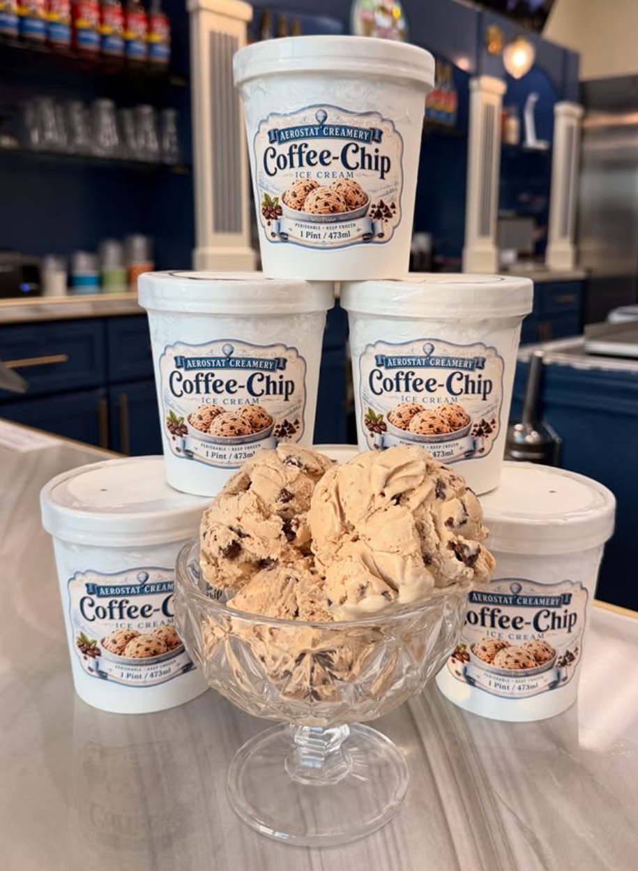 Stack of coffee chip ice cream pints and a bowl of coffee chip ice cream.